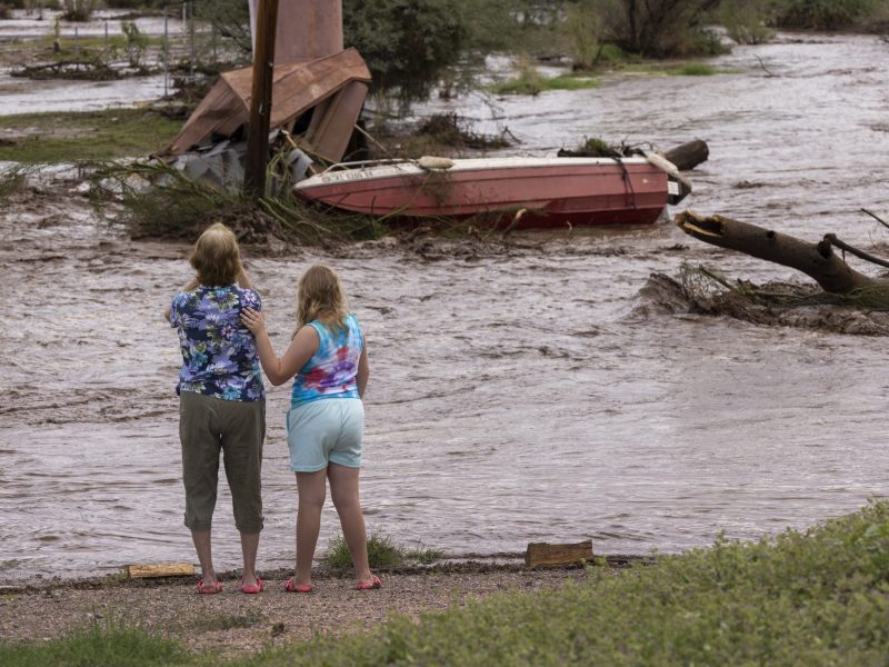 ﻿In Roosevelt, Arizona, two residents look at possessions washed away by a flash flood