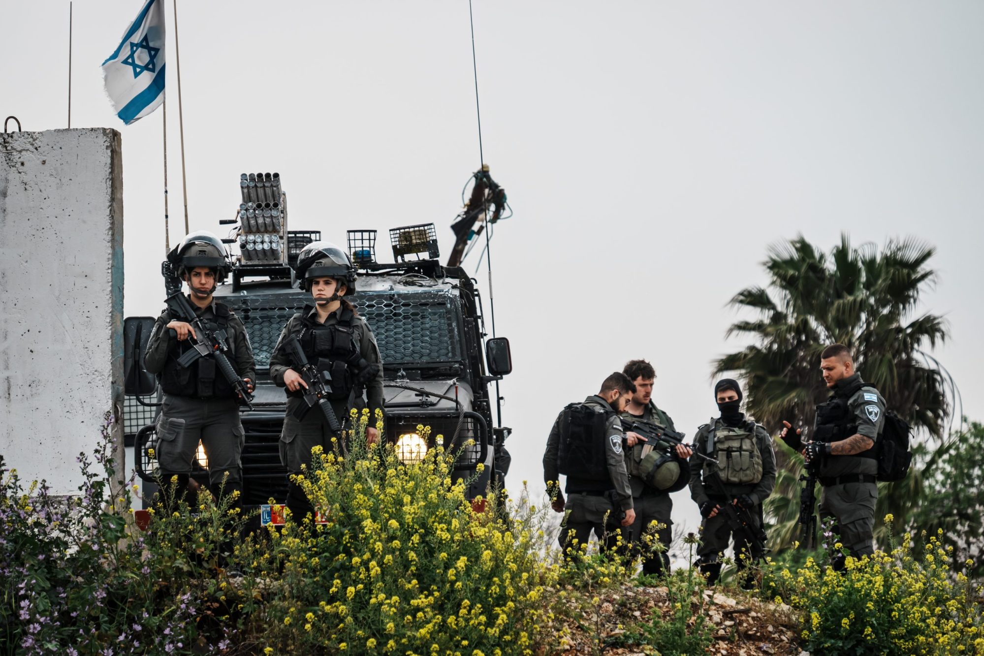 Israeli soldiers stand armed and ready as they watch over West Bank Palestinian residents with conditional permits, cross into a checkpoint to enter Jerusalem to pray at the Al-Aqsa in the Old City for Ramadan, in Qalandia, Occupied West Bank , Friday, March 29, 2024. MARCUS YAM / LOS ANGELES TIMES
